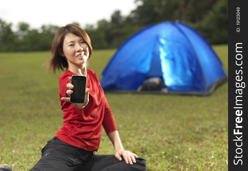 Asian Female Camper Showing Her Mobile Phone