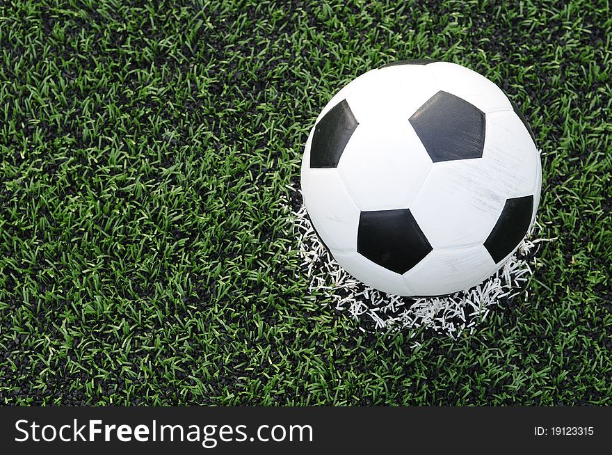 Close up of soccer ball on the center of soccer field