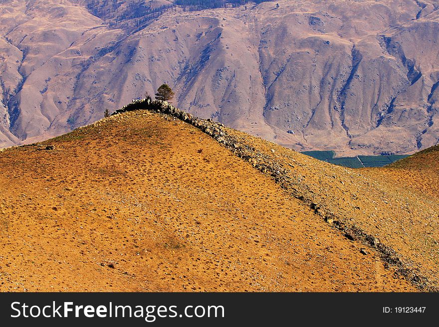 Swakane Canyon near Wenatchee Washington; a natural rock formation ontop of a rolling hill in the canyon