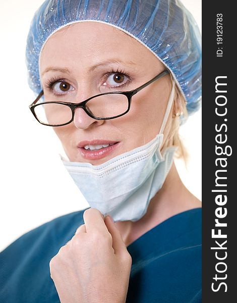 Face of a caucasian woman doctor wearing protective hair net and face mask wearing dark glasses. Face of a caucasian woman doctor wearing protective hair net and face mask wearing dark glasses