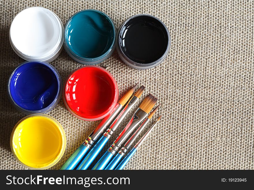 Set of paintbrushes and color paint on canvas background. Set of paintbrushes and color paint on canvas background