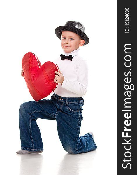 Cute boy with red heart isolated on white