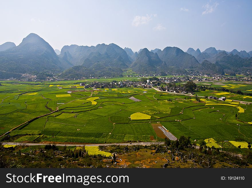 Small Village in Grassland surround with beautiful mountains in Kunming, China.