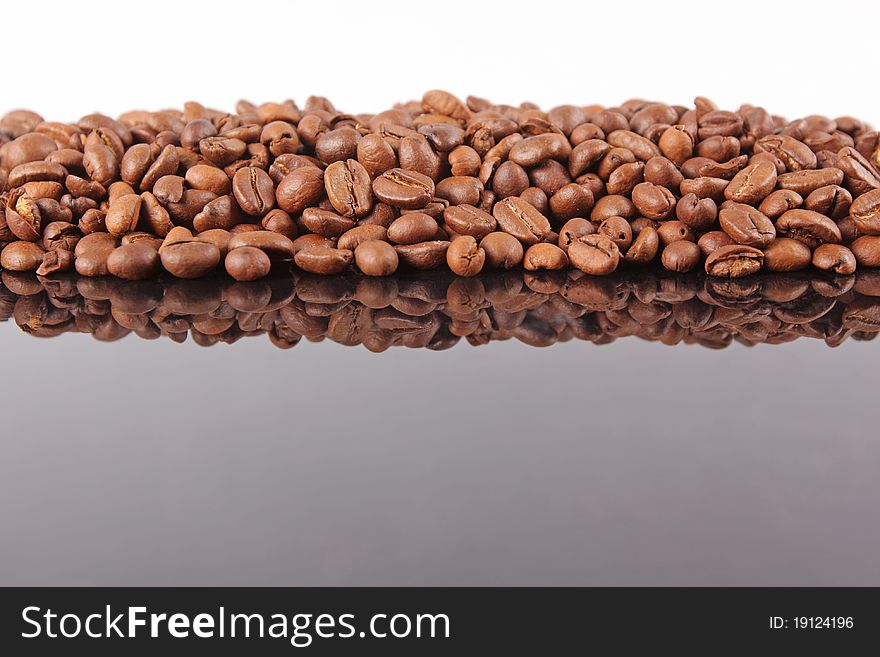 Coffee Beans background, reflected on black glass