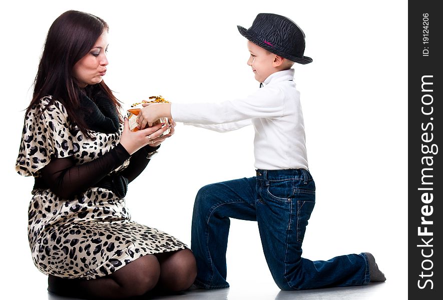 Cute boy giving a present to his mother isolated on white