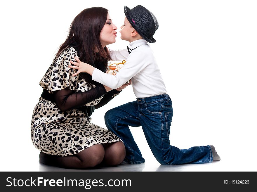 Cute boy kissing his mother isolated on white