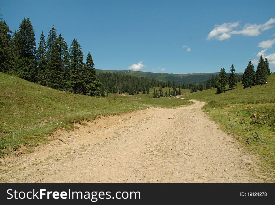 Winding dirt lane ascending a mountain