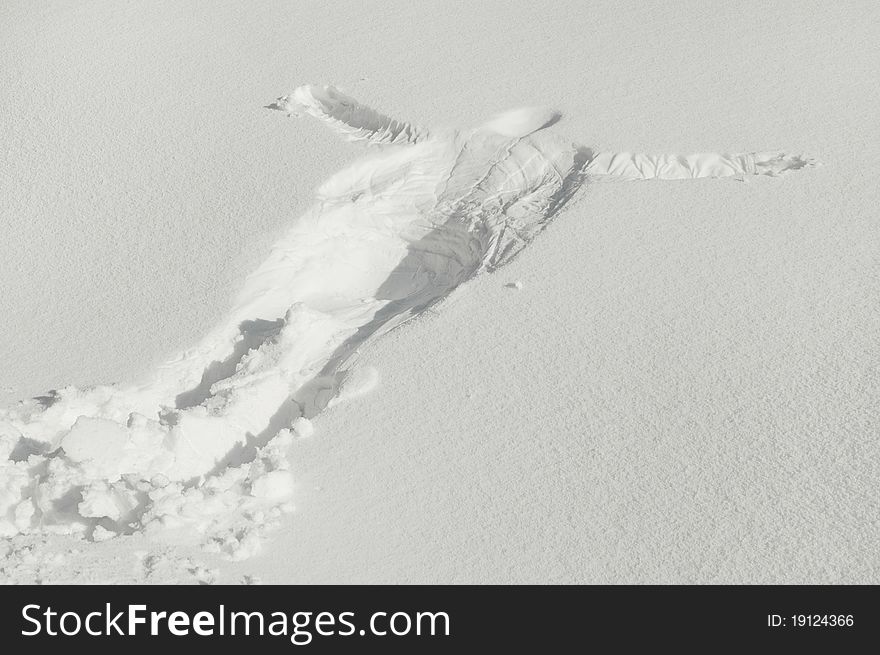 Beautiful snow angel made in total relaxation, in deep snow, greeting winter