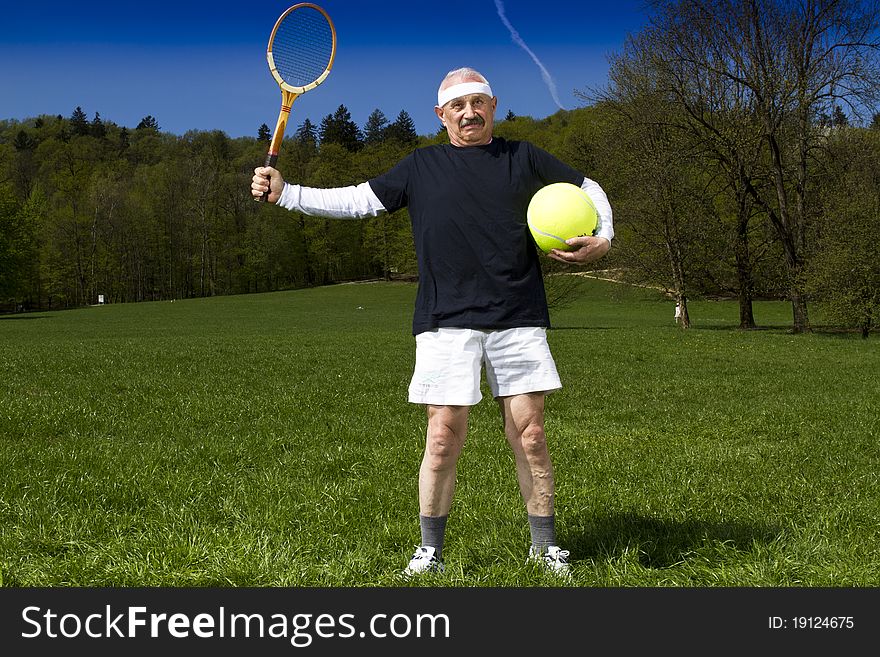 Senior man playing tennis