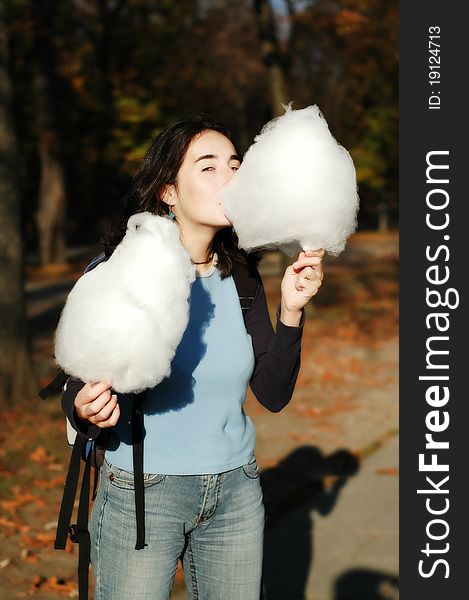 Girl eating cotton candy in the park