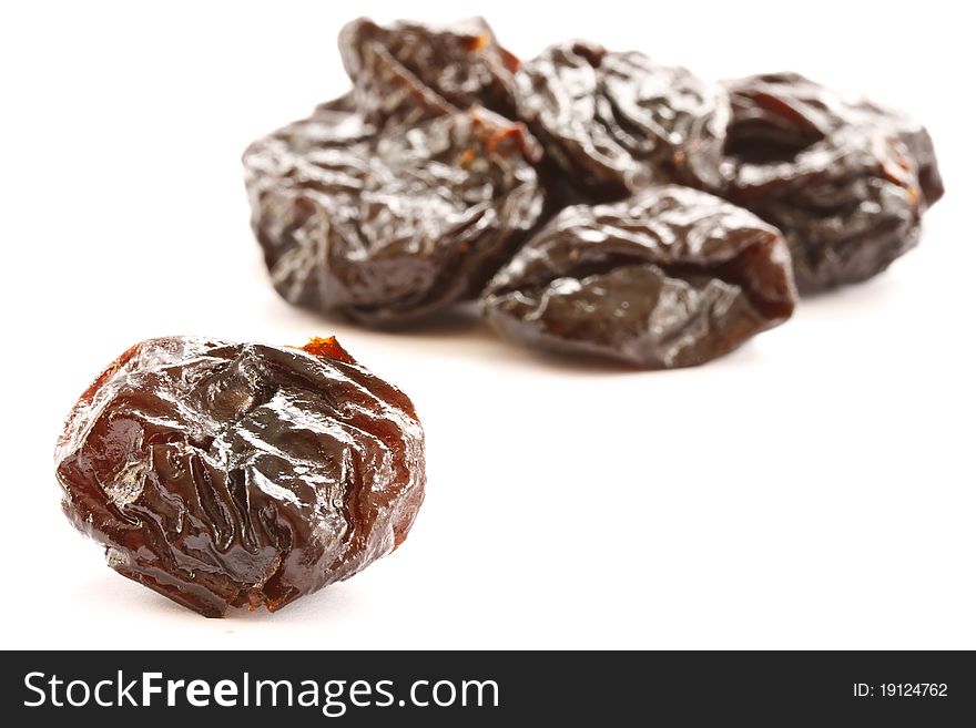 Delicious dried plums isolated on a white background