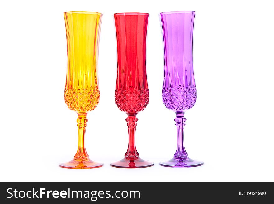 Three multicolored wineglasses isolated on white background