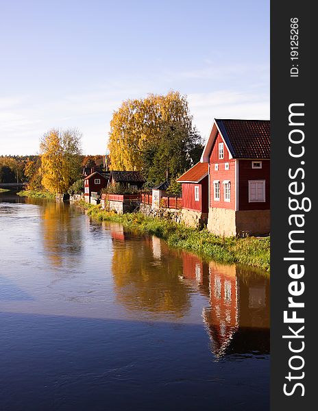 Swedish village at the riverside, reflections in the water. Swedish village at the riverside, reflections in the water.