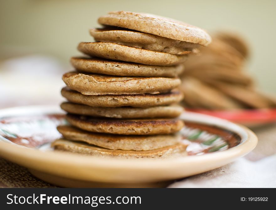 Stack of sweet oat pancakes on a ceramic plate. Stack of sweet oat pancakes on a ceramic plate