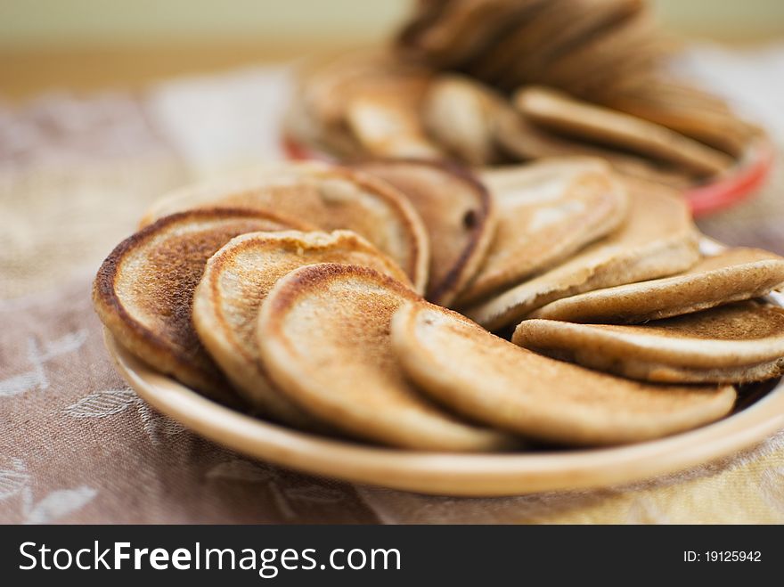 Stack of sweet oat pancakes on ceramic plate. Stack of sweet oat pancakes on ceramic plate