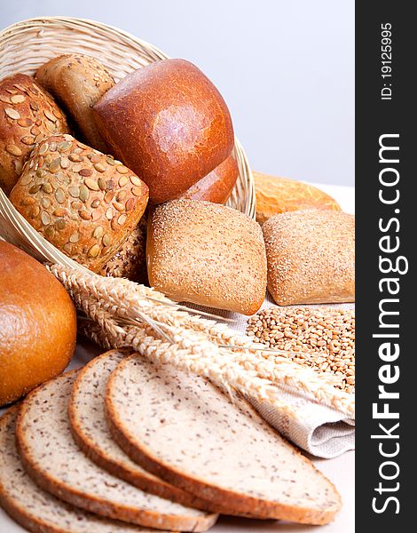Assortment of baked bread with ears of wheat. Assortment of baked bread with ears of wheat