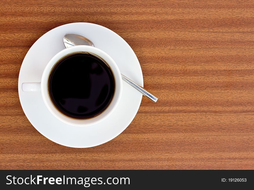 Cup of black coffee on wooden table