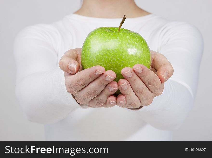 Woman holding green apple in her hands. isolated on white background. Woman holding green apple in her hands. isolated on white background