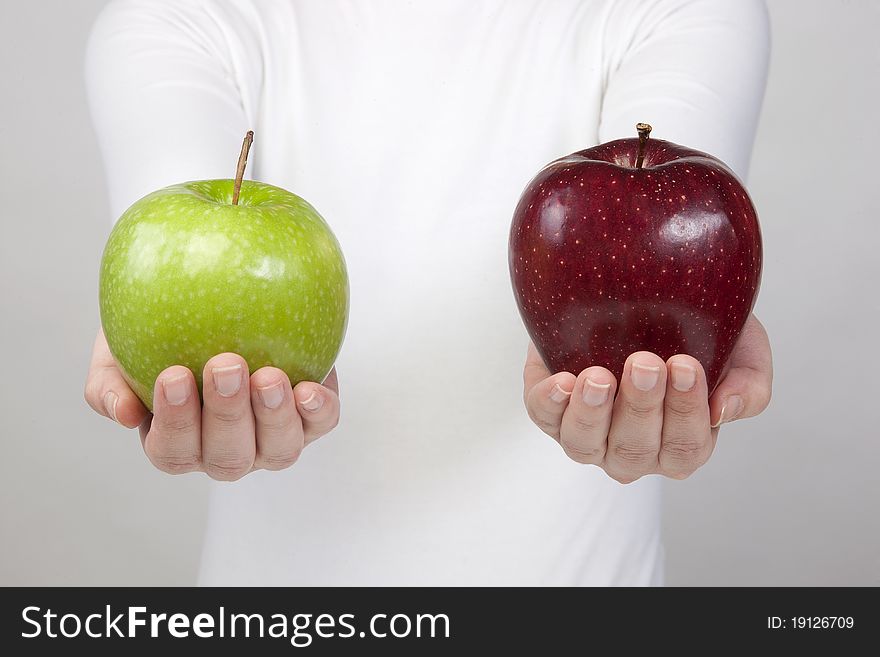 Woman holding two apple\'s in hands isolated on white