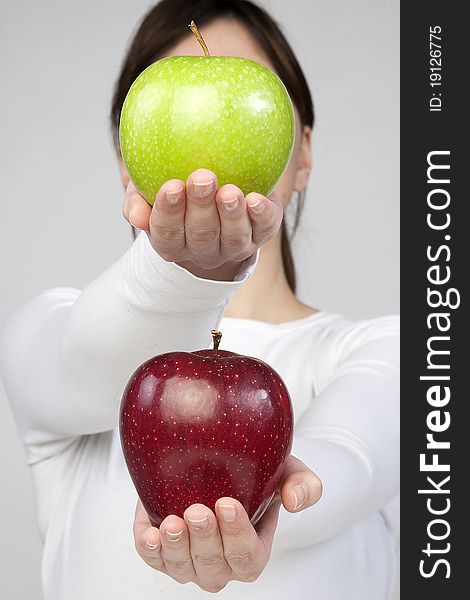 Woman holding two apple's in hands isolated on white