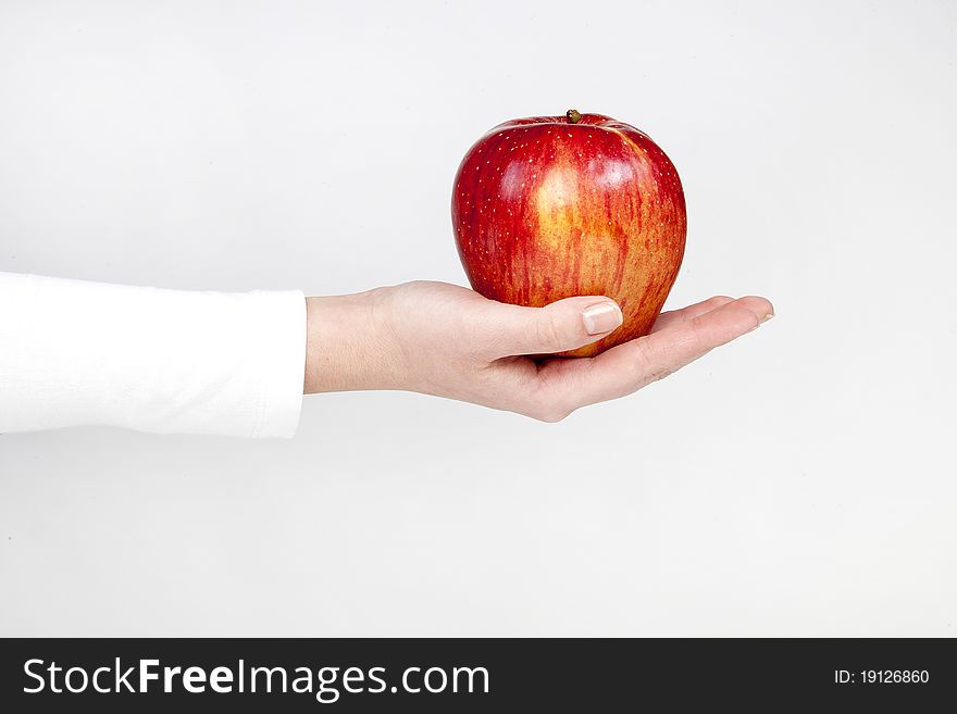 Healthy red apple in woman hand, isolated on white. Healthy red apple in woman hand, isolated on white