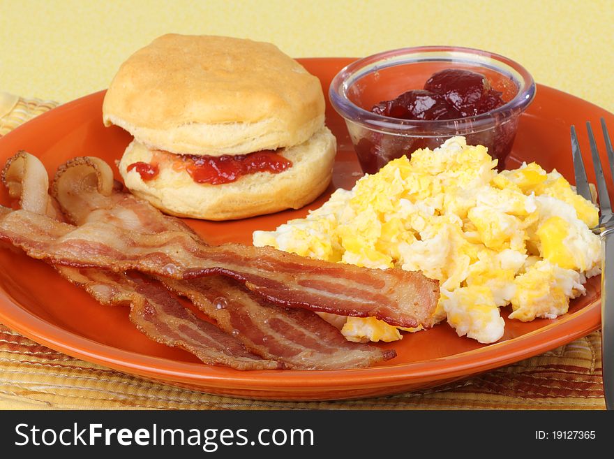 Bacon with scrambled eggs and a biscuit. Bacon with scrambled eggs and a biscuit