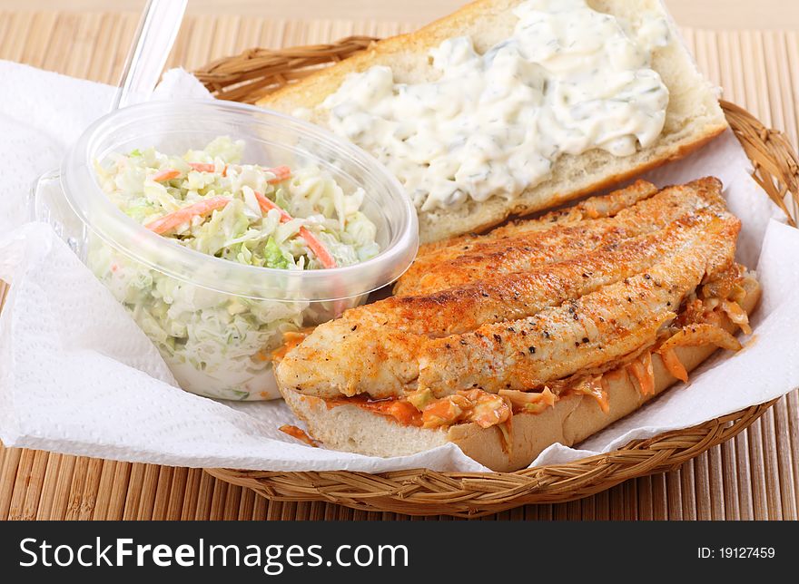 Catfish fillet sandwich with coleslaw in a basket