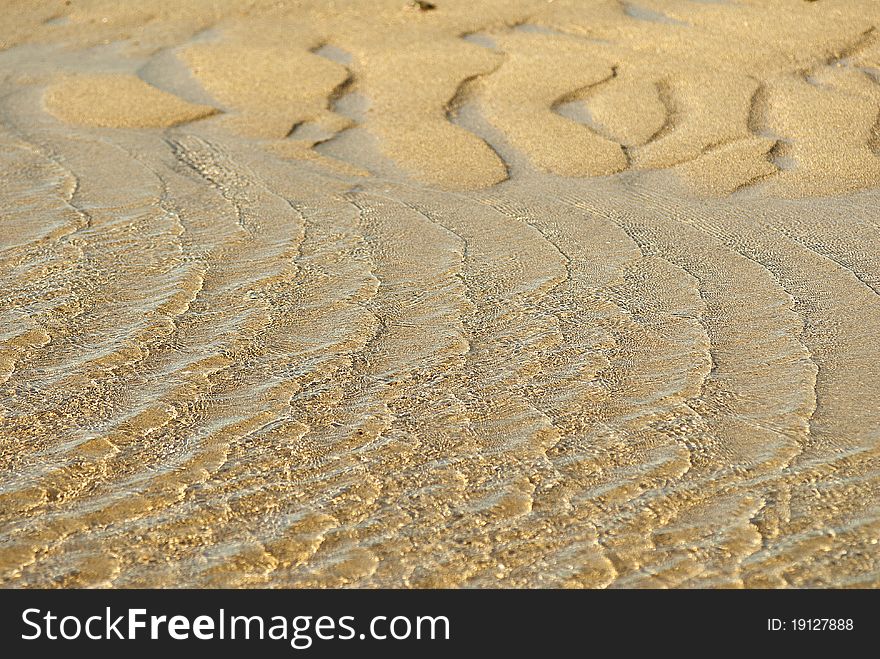 Waves in the sun. The waves on the reflection of sunlight in a shallow sandy sea. Waves in the sun. The waves on the reflection of sunlight in a shallow sandy sea.