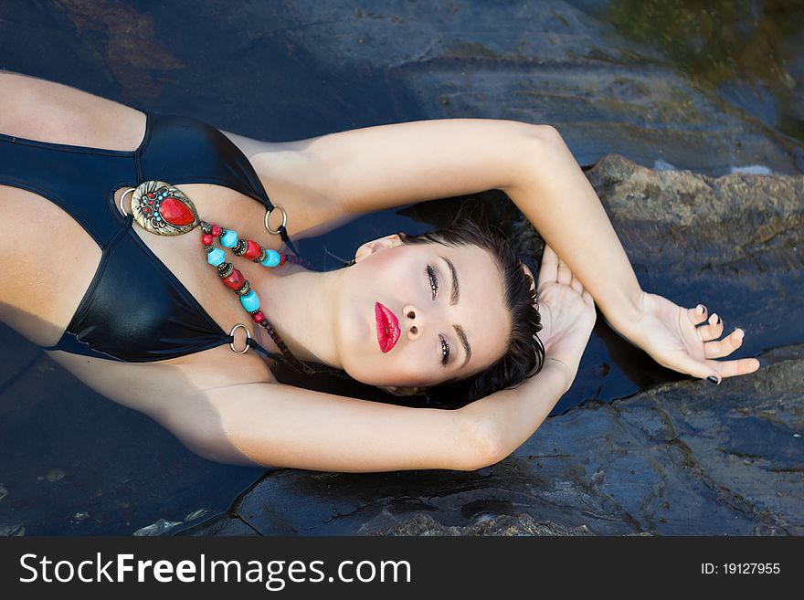 Bright portrait of a brunette resting in the water. Bright portrait of a brunette resting in the water