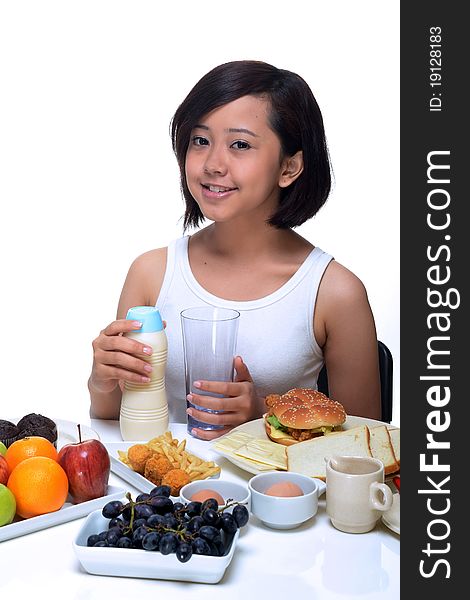 An attractive Asian woman eating a healthy breakfast