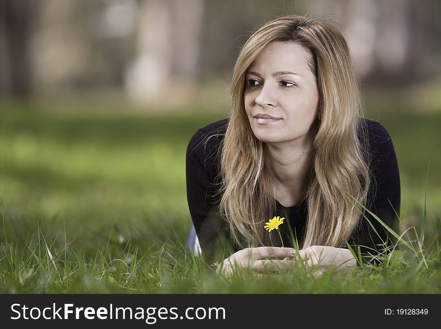 Young woman sitting on grass