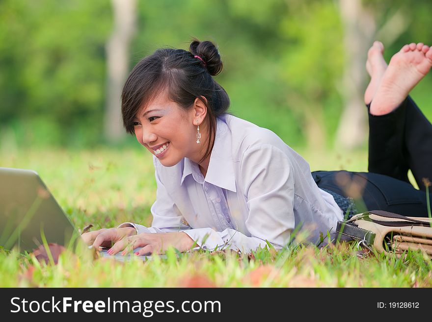 Business woman staying connected while out in the park. Business woman staying connected while out in the park