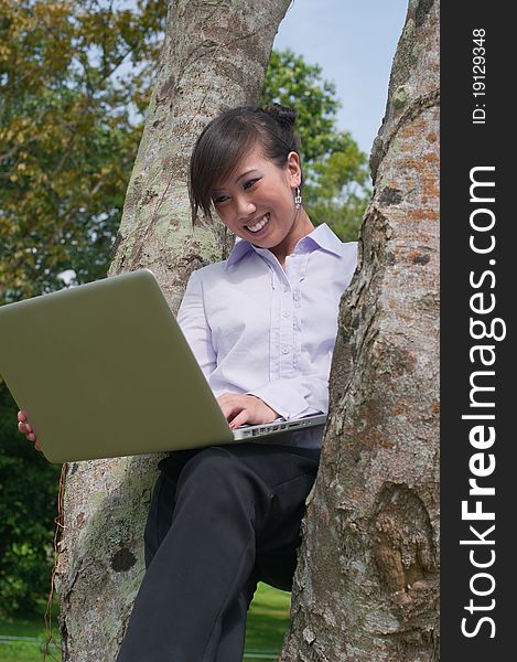 Business woman staying connected while out in the park. Business woman staying connected while out in the park