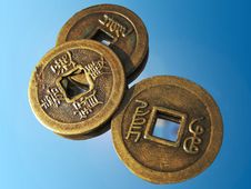 Three Ancient Chinese Coins On A Mirror Royalty Free Stock Photography