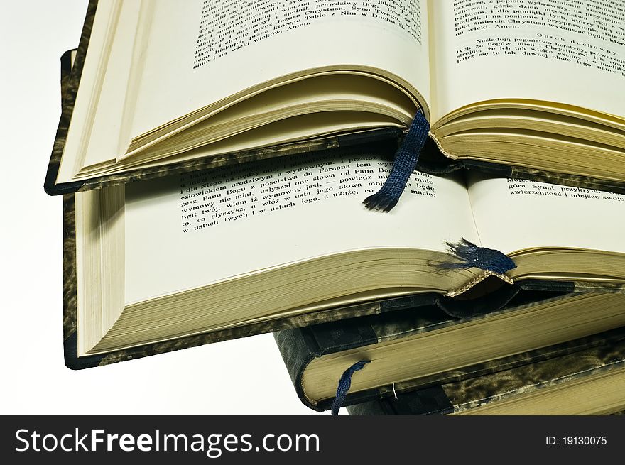 Stack of old books on white