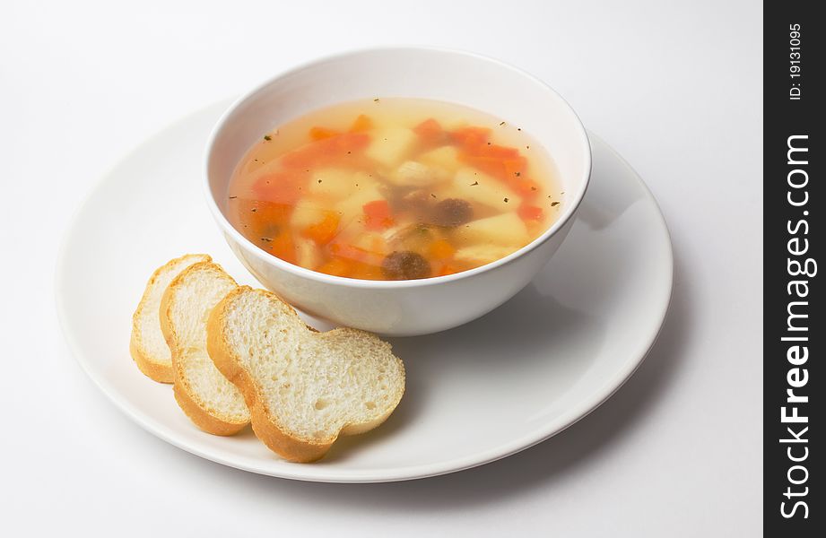 A delicious chicken soup with crispy baguette