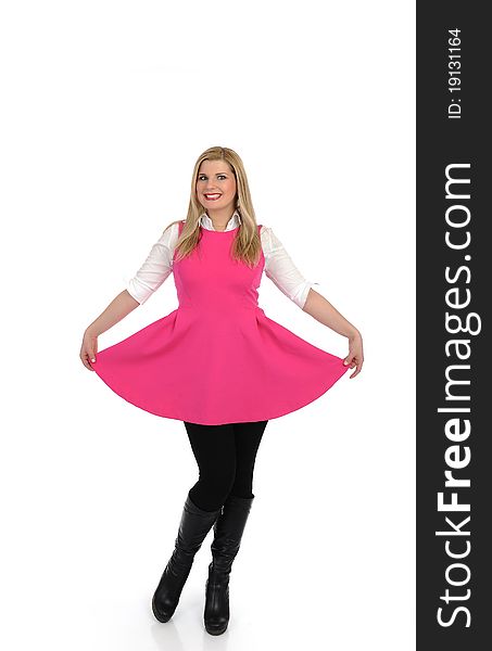 Pretty woman in pink dress standing. studio shot. isolated