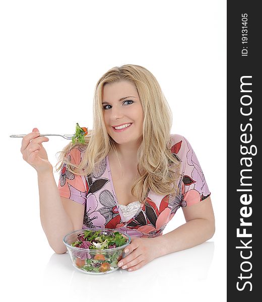 Beautiful woman eating green vegetable salad.