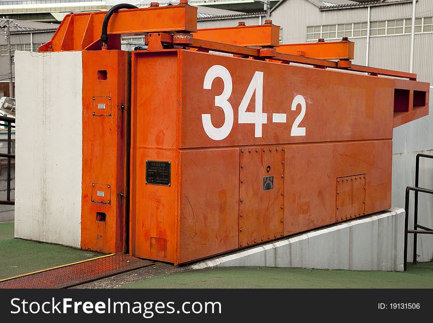 A japanese tsunami water tight door in osaka city port area with the numbers 34 and 2 on it