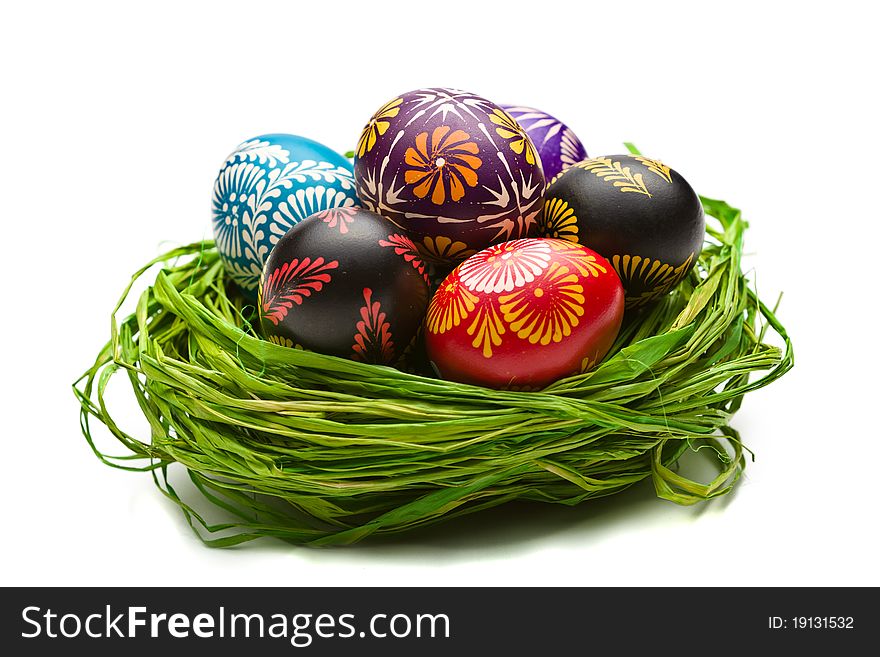 Painted easter eggs in basket on white background. Painted easter eggs in basket on white background