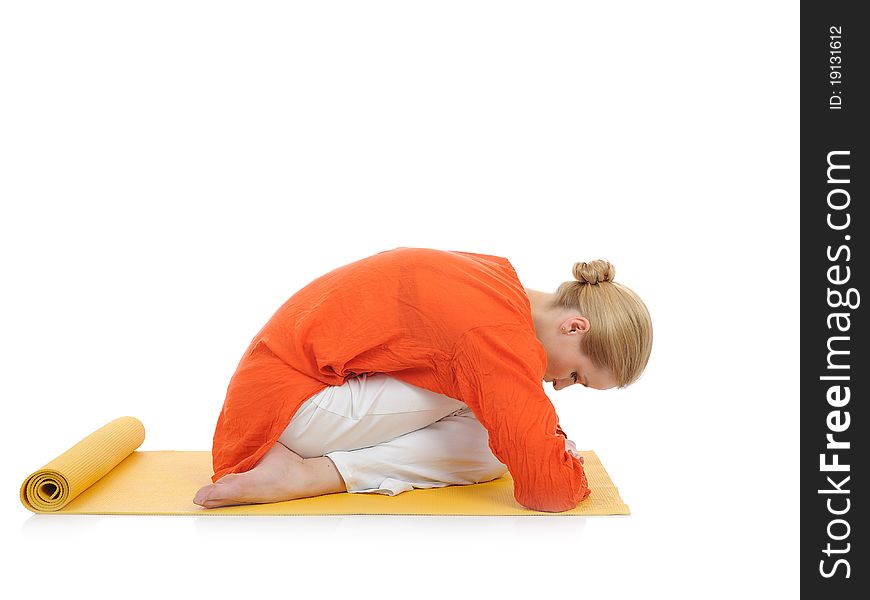 Series or yoga photos.young woman in virasana pose on yellow pilated mat