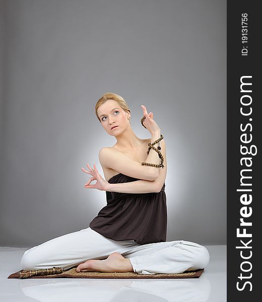 Creative portrait of young woman in yoga pose
