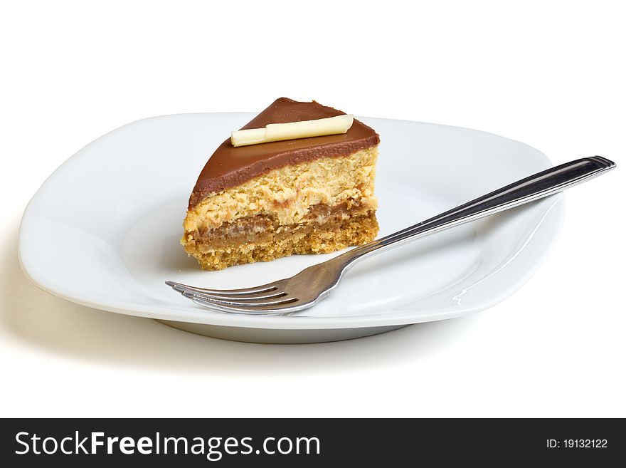 Chocolate Caramel Cheesecake on plate with fork isolated on white.