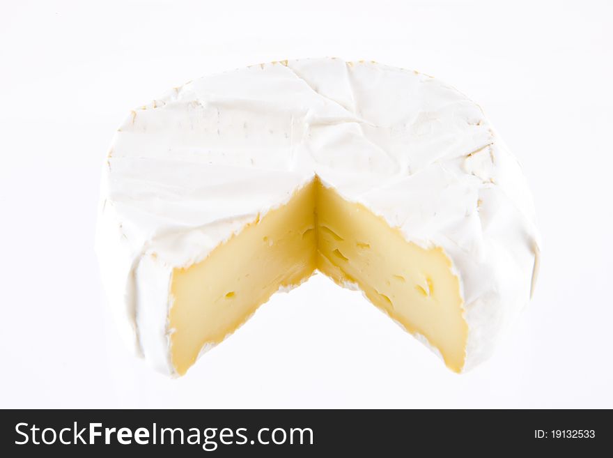 A pice of french cheese on a white background