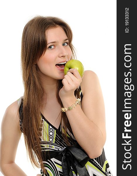 Portrait of cheerful young woman holding a  green apple and smiling isolated against white background