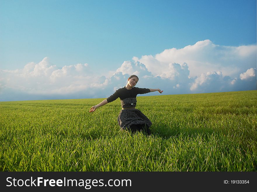 Young girl posing on a green grass field. Young girl posing on a green grass field