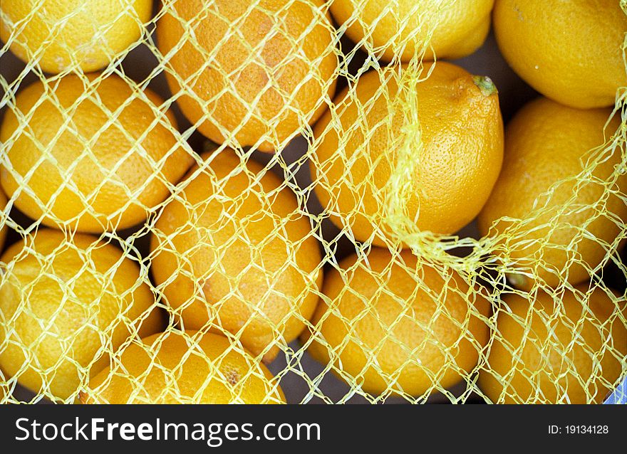 Yellow lemon fruits in a string bag,shopping. Yellow lemon fruits in a string bag,shopping