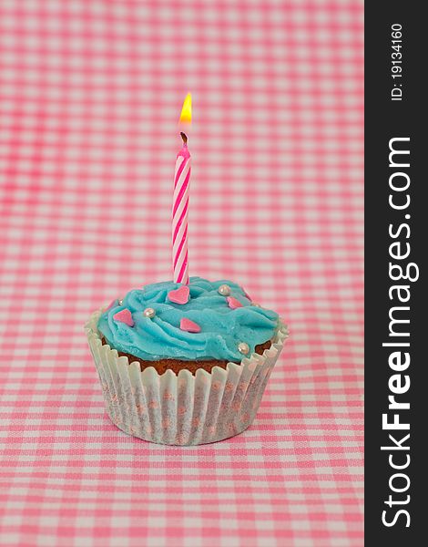 Birthday cupcake with candles on a yellow background. Birthday cupcake with candles on a yellow background
