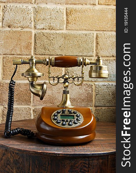 Vintage luxurious telephone old fashion on brick wall background
