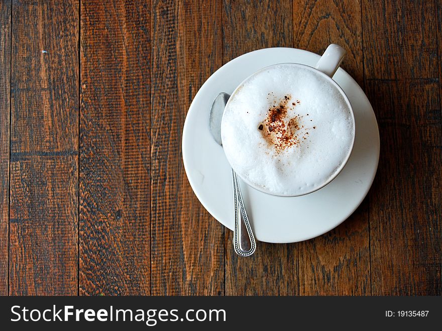 Cup of coffee cappuccino on vintage wood background. Cup of coffee cappuccino on vintage wood background
